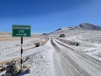 A snowy road leads to gurudongmar lake.