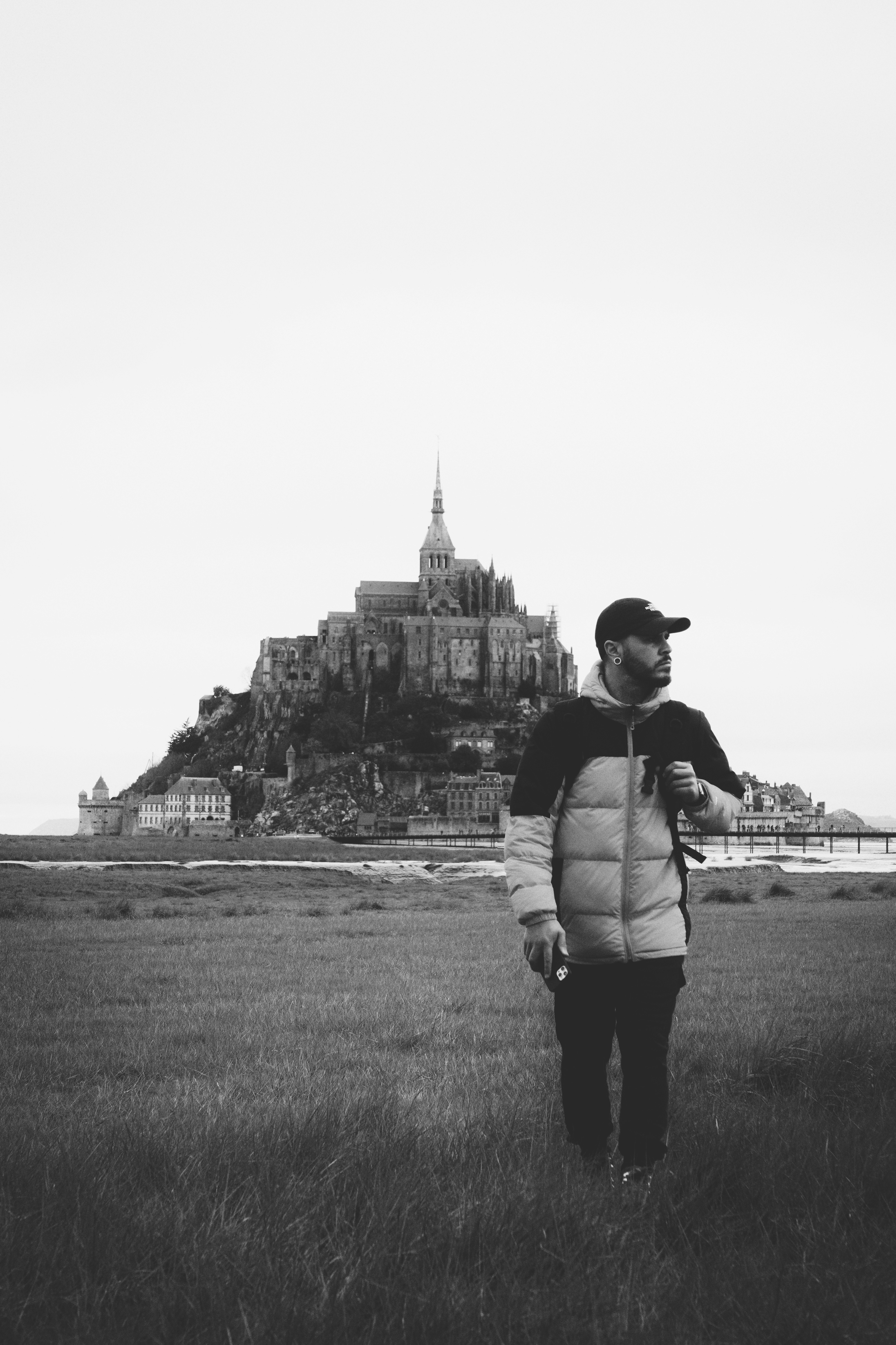 Man stands before majestic castle.
