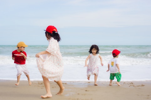 Children are happily playing on the beach.