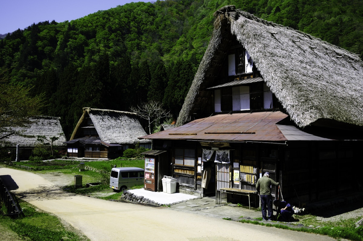 Traditional Japanese village houses in a scenic hillside setting, representing residential communities accessible by bridge from Kobe