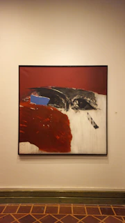 Abstract painting on a white wall.