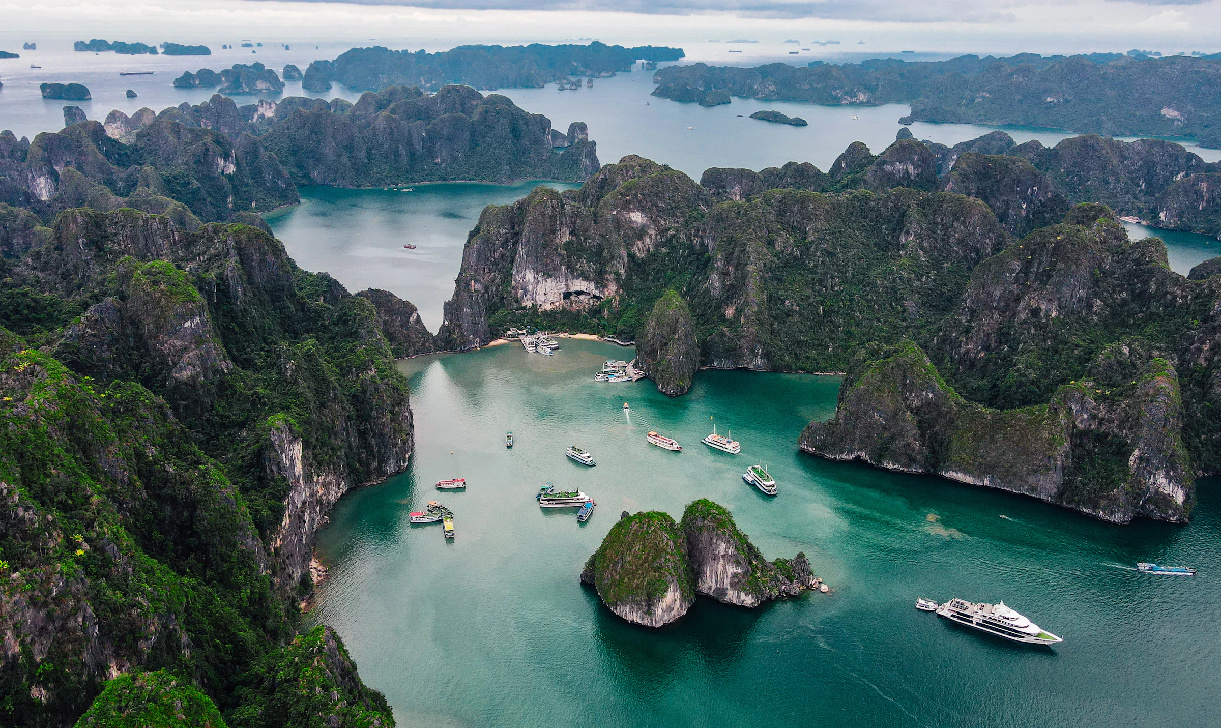 Islands rising from a turquoise bay, seen from the air