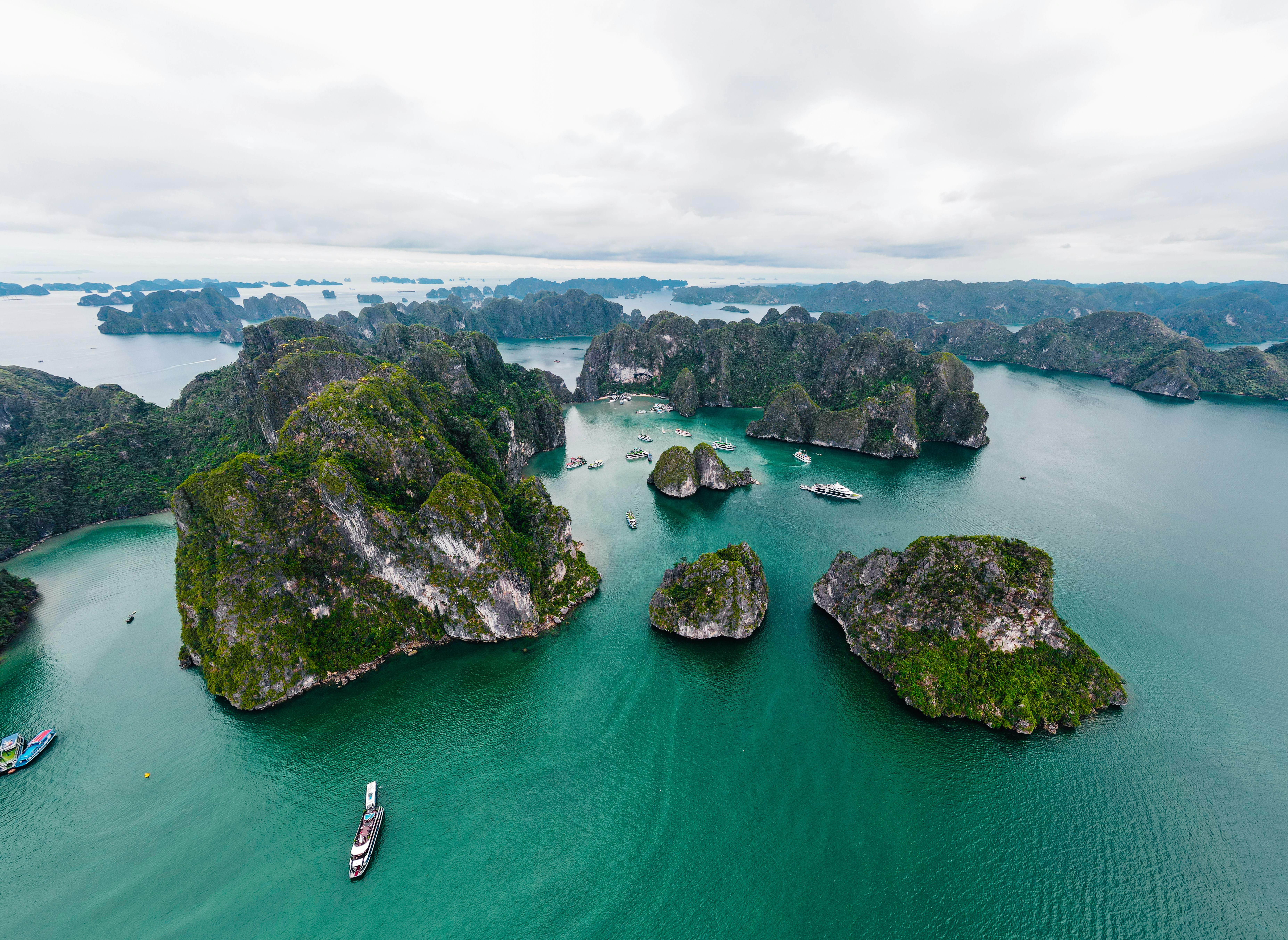 Rocky islands rise out of the calm, turquoise water.