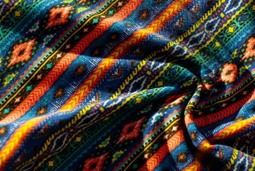Vibrant fabric with a colorful, intricate pattern.