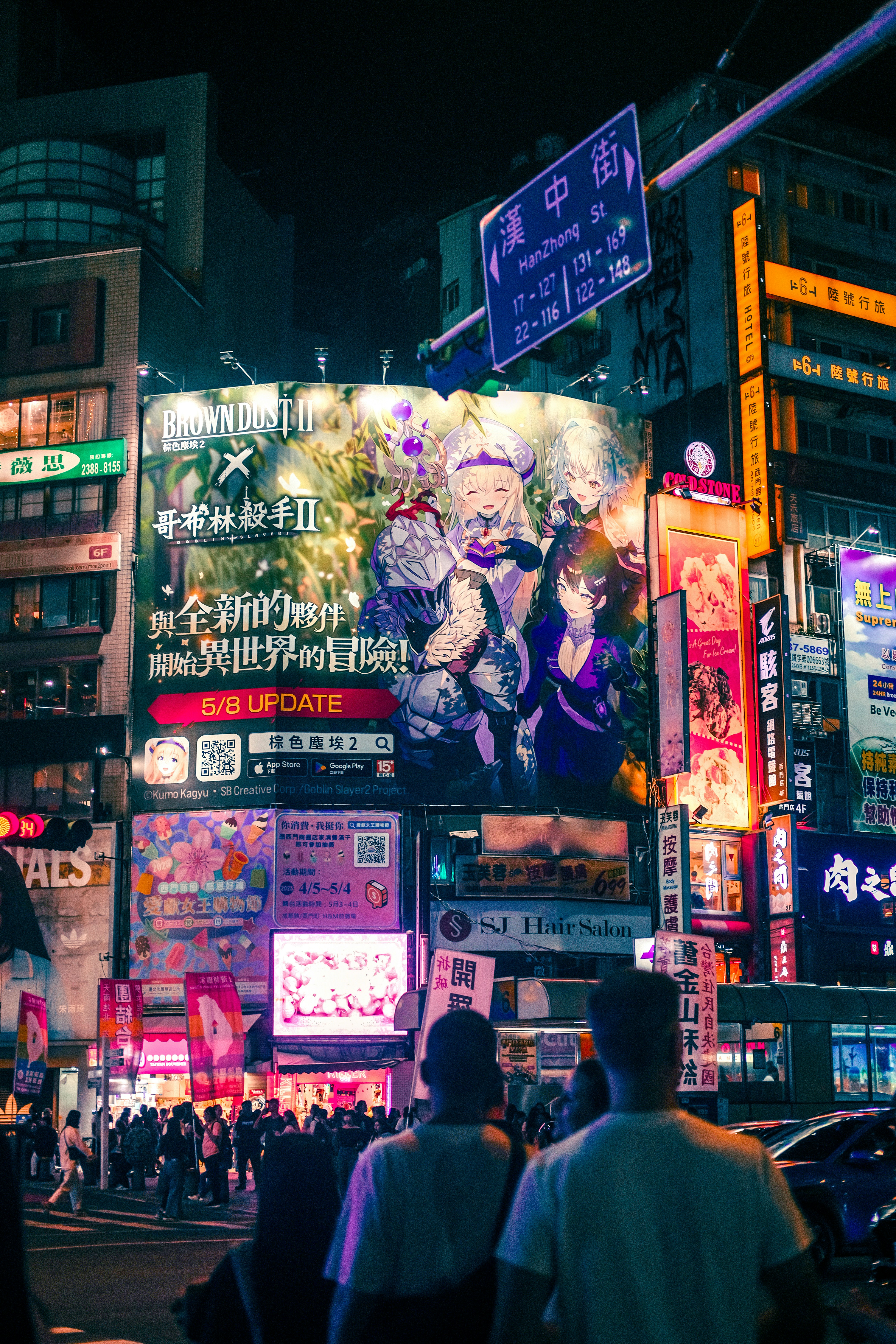 Nighttime cityscape filled with bright signs and people.