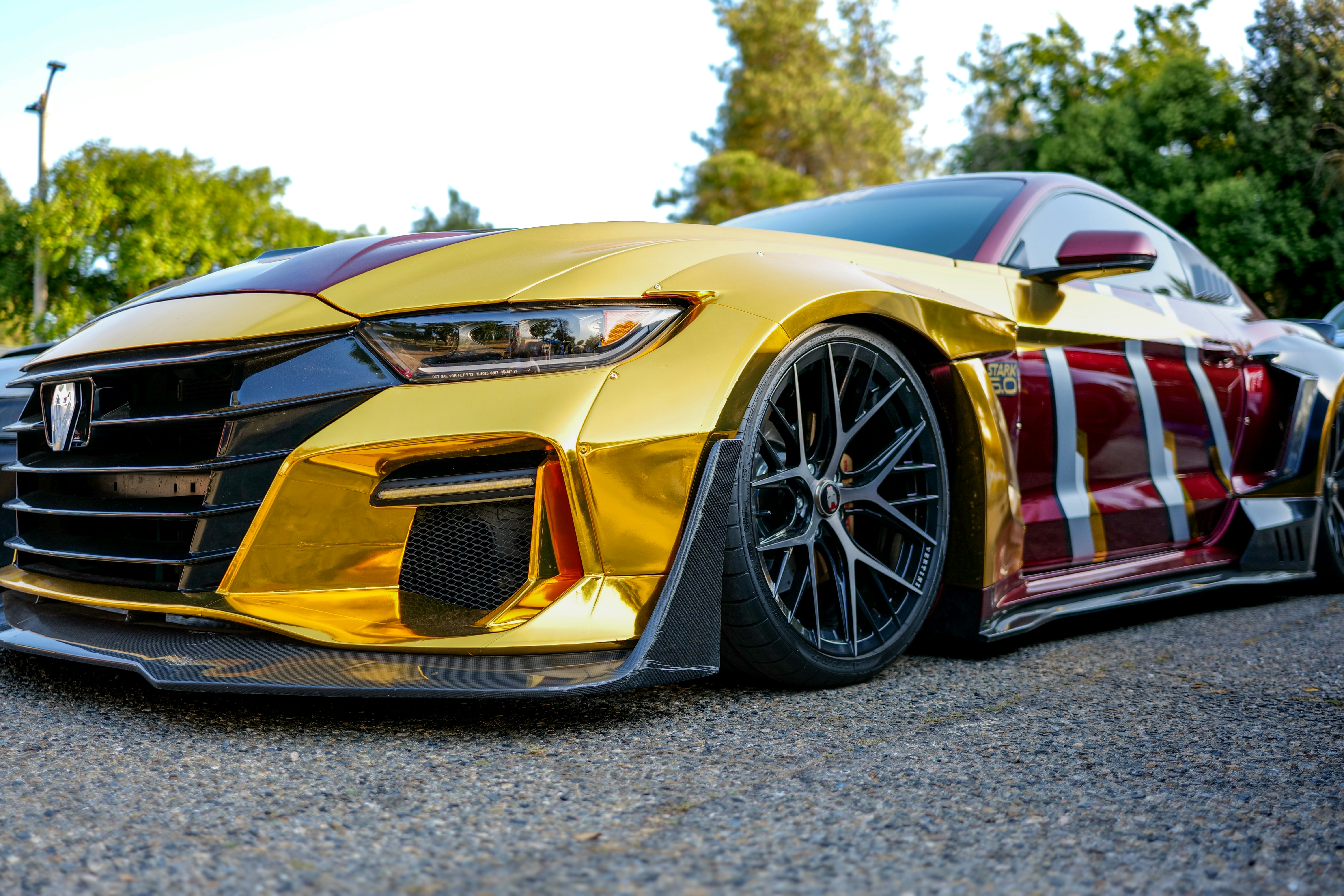 A gold and maroon modified car is shown.