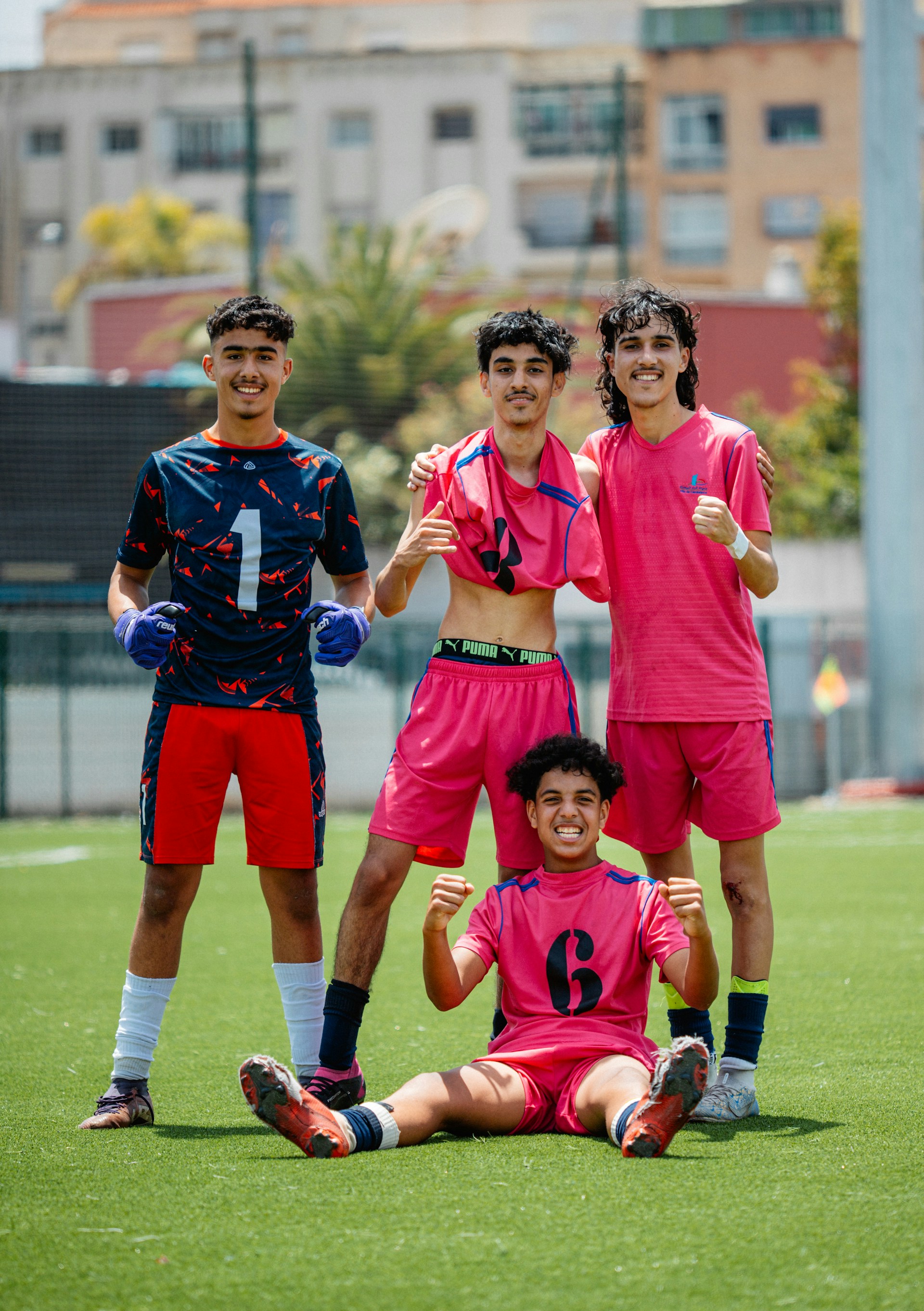 A soccer team poses proudly on the field.