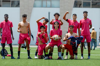 A soccer team poses for a celebratory photo.
