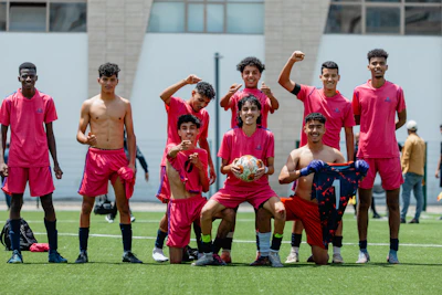 A soccer team poses for a celebratory photo.