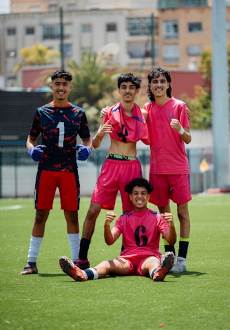 A soccer team celebrates their victory on the field.