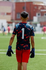 Soccer player wearing number one, facing away.