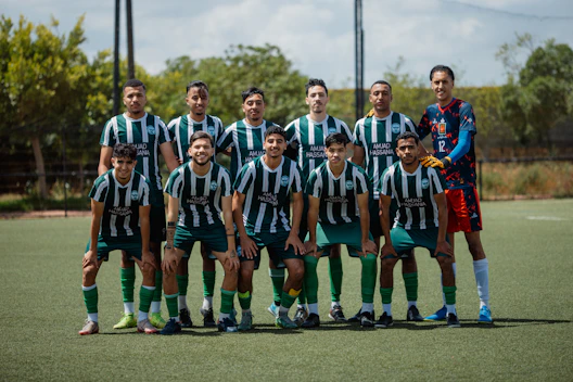 A soccer team stands together on a field