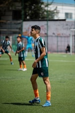 Soccer players in a game on a green field.