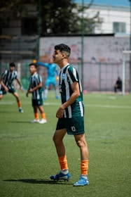 Soccer players in a game on a green field.