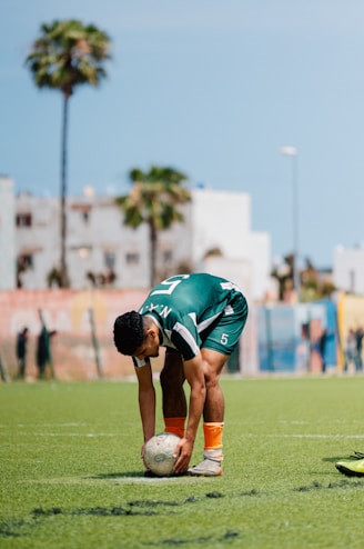 Soccer player prepares to kick a ball on the field.