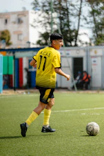 A young soccer player kicks the ball.