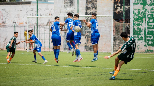 A soccer player kicks the ball in a game.