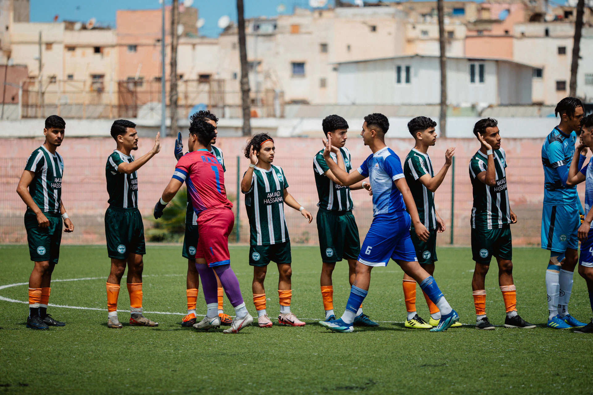 Soccer players are shaking hands before the game
