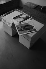 Photos rest on a glass coffee table.