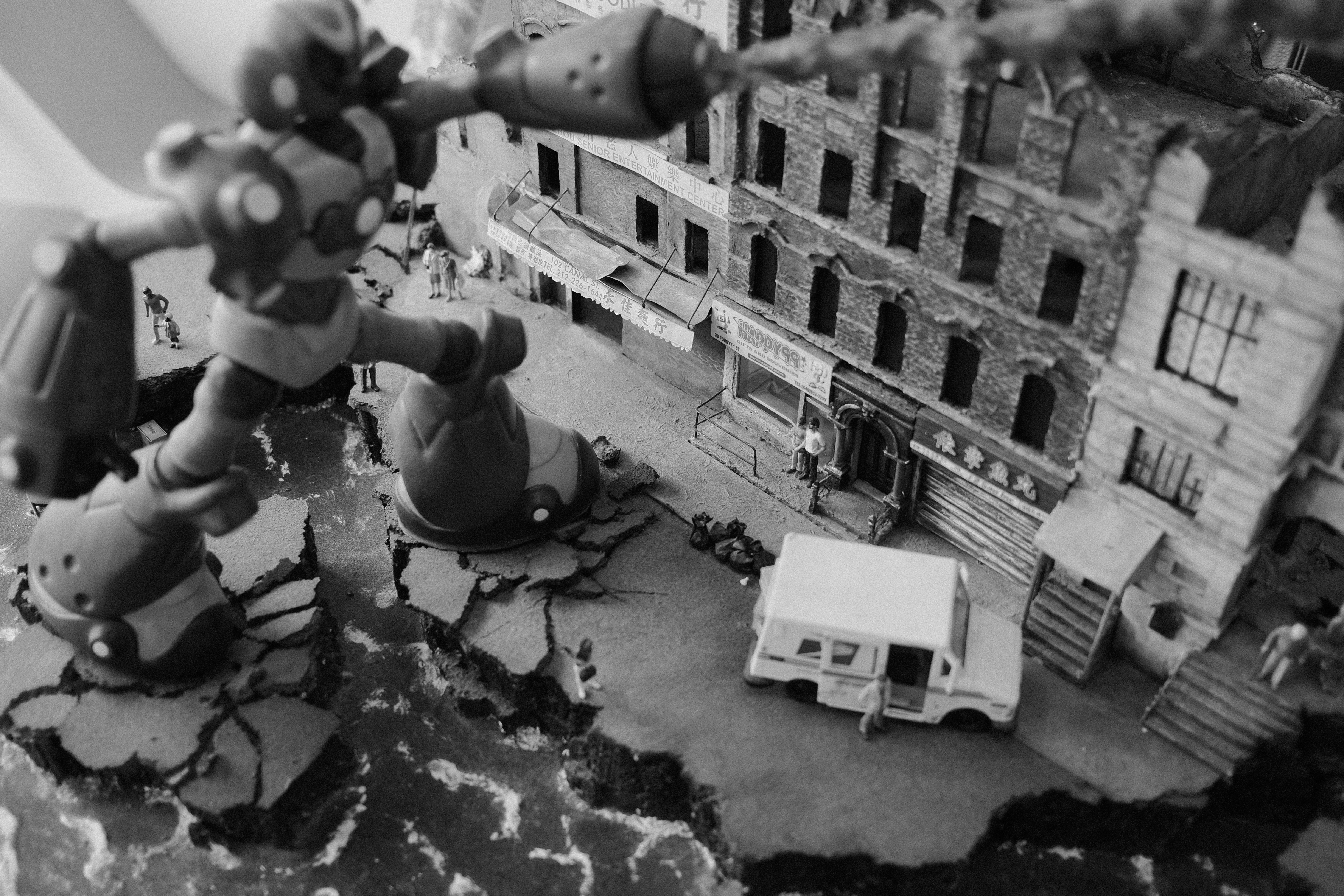Robot destroys buildings in a miniature cityscape.