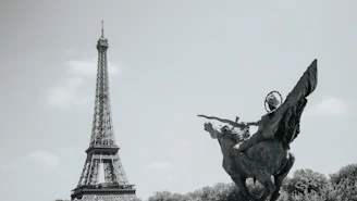 The eiffel tower and a statue in paris.
