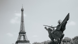 The eiffel tower and a statue in paris.