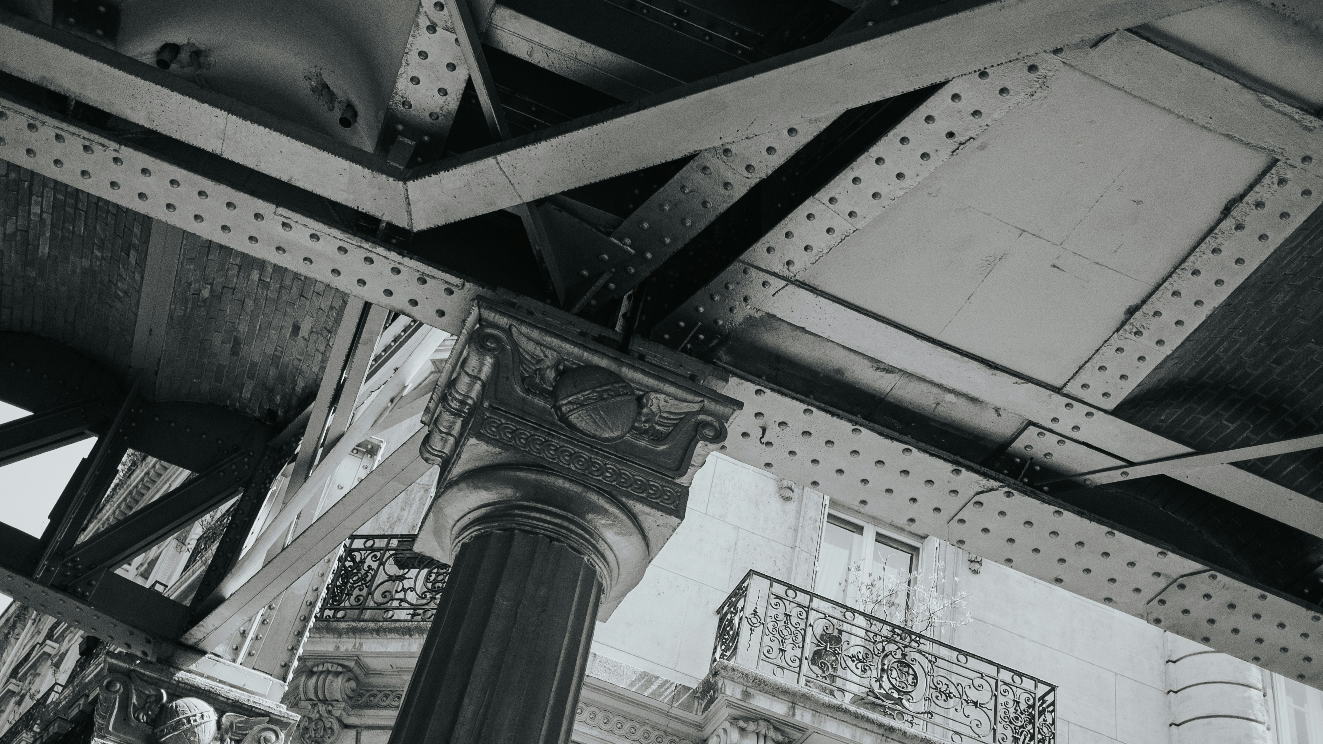 A black and white image of architecture and metal.