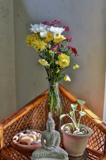 Flowers and buddha decorate a cozy corner.