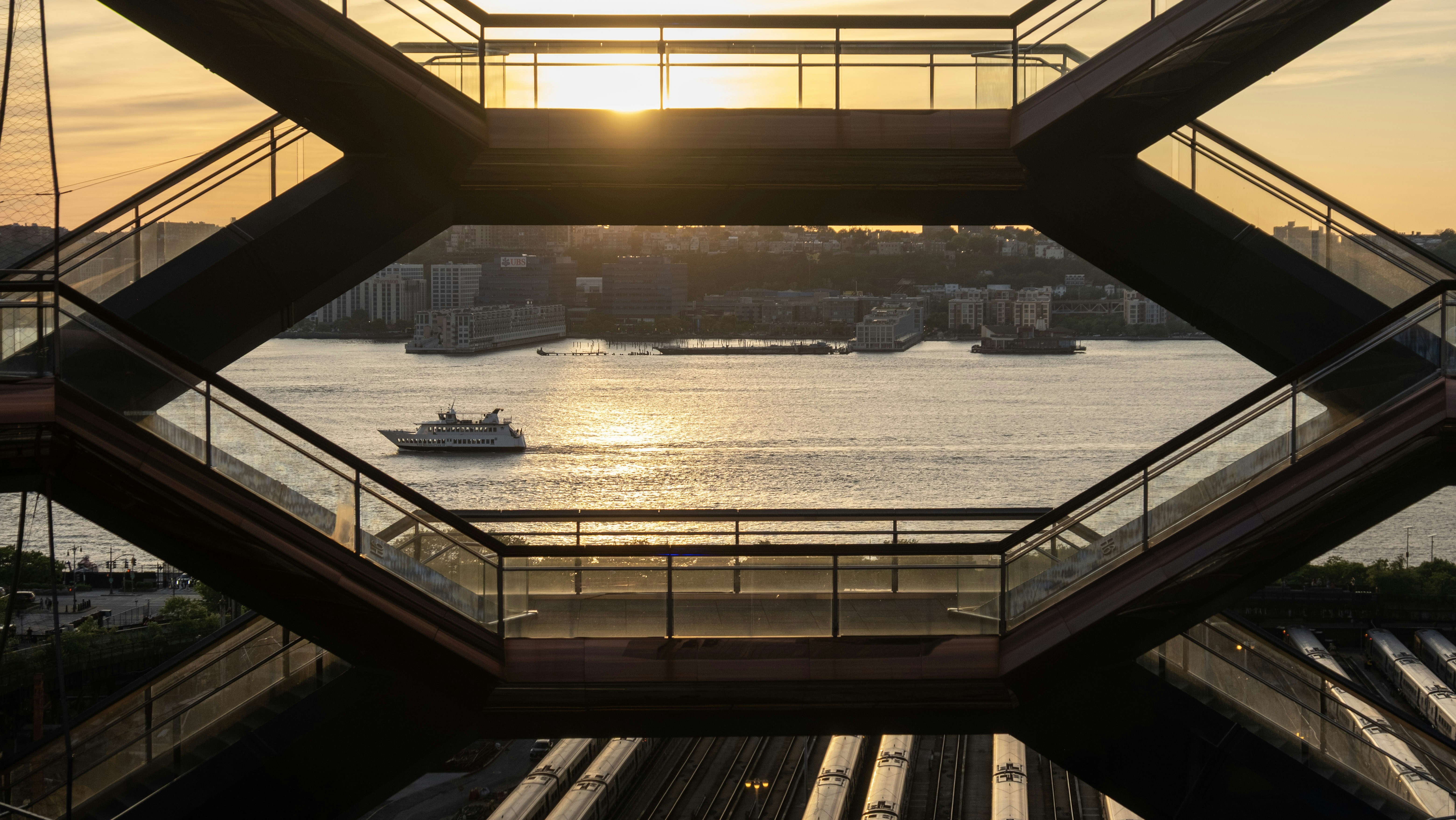 The vessel framing the hudson river at sunset.