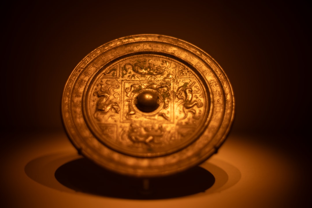 An ornate, ancient chinese bronze mirror.,
