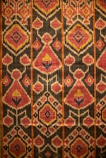 Here is a caption: a detailed pattern of colorful fabric.