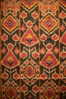 Here is a caption: a detailed pattern of colorful fabric.