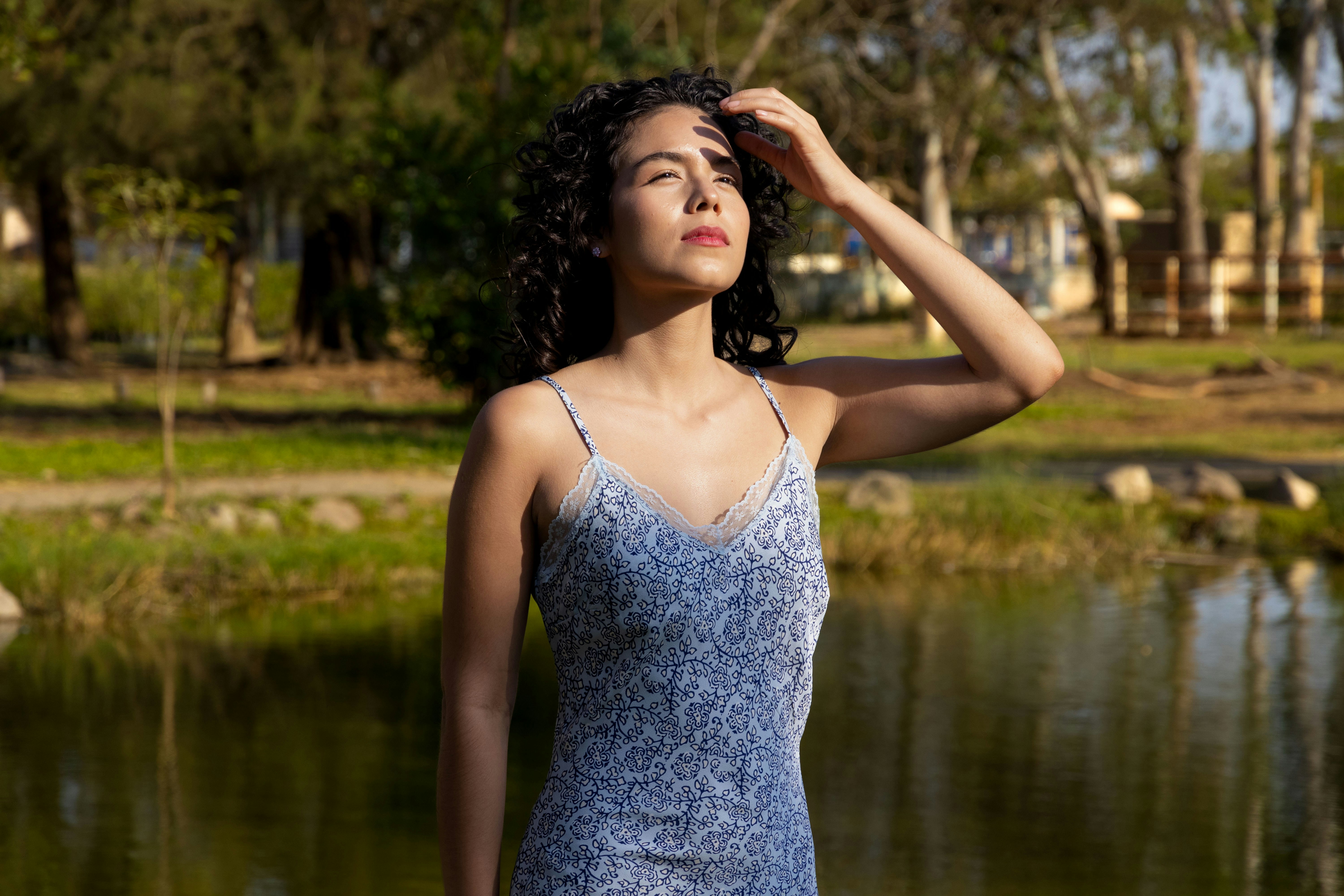 A woman shields her eyes in sunlight