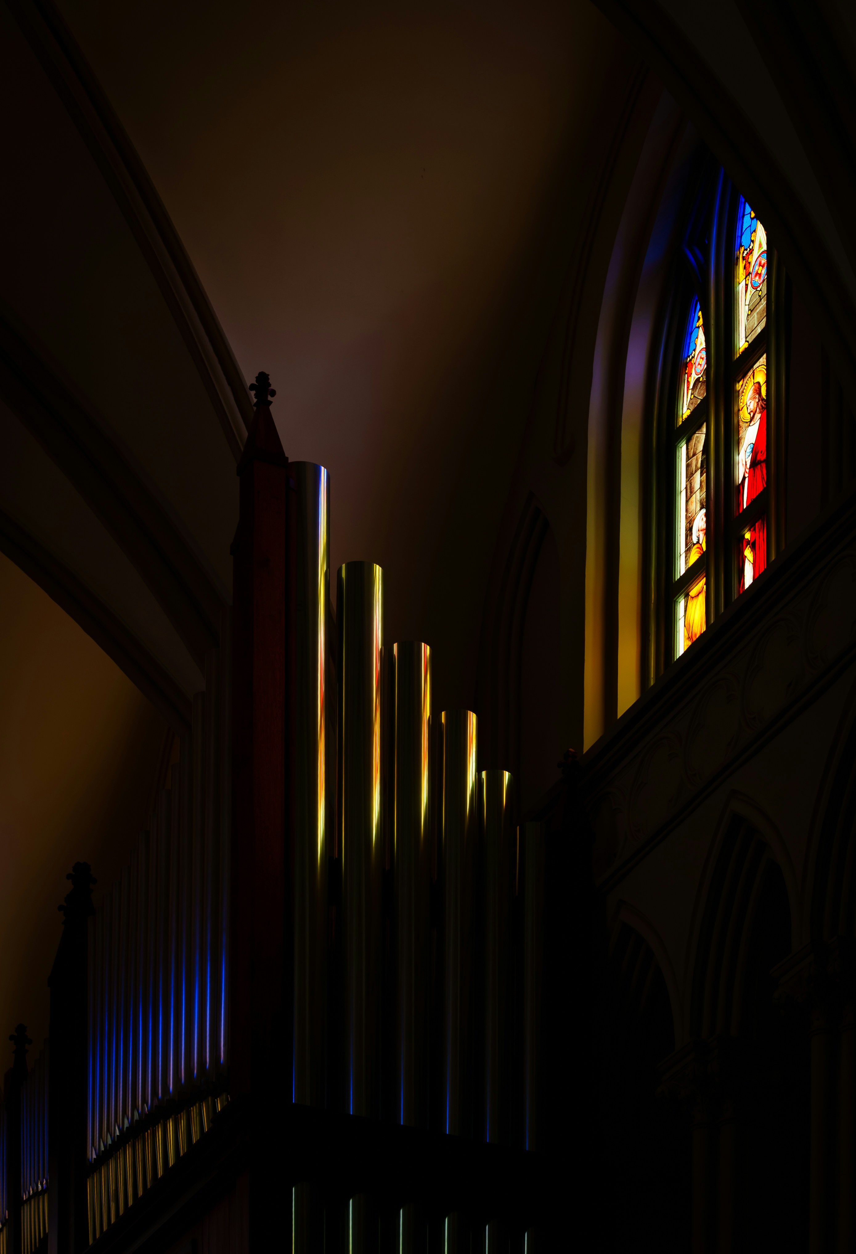 Organ pipes and stained glass window.