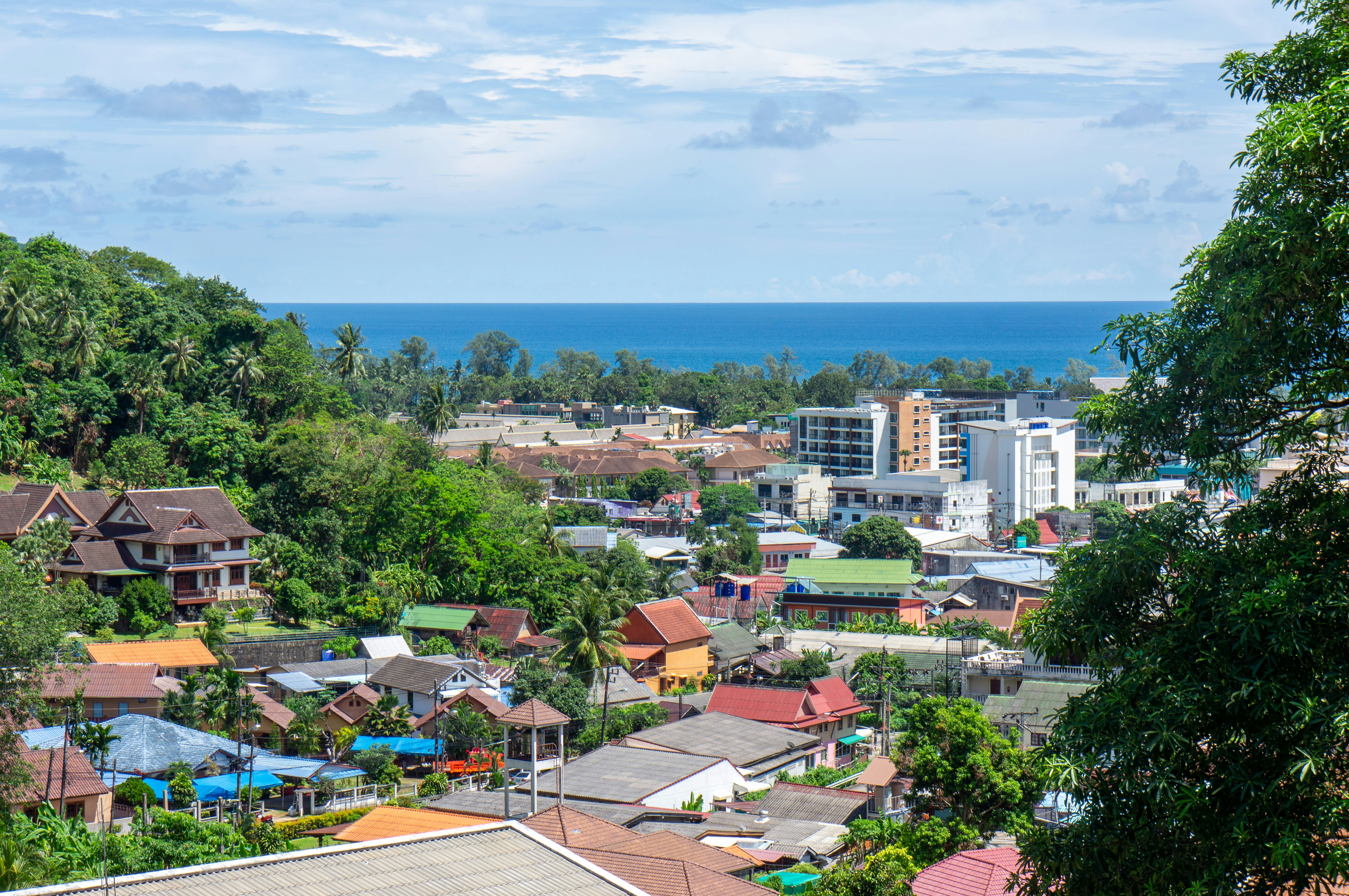 Cityscape view of houses and buildings near the ocean.