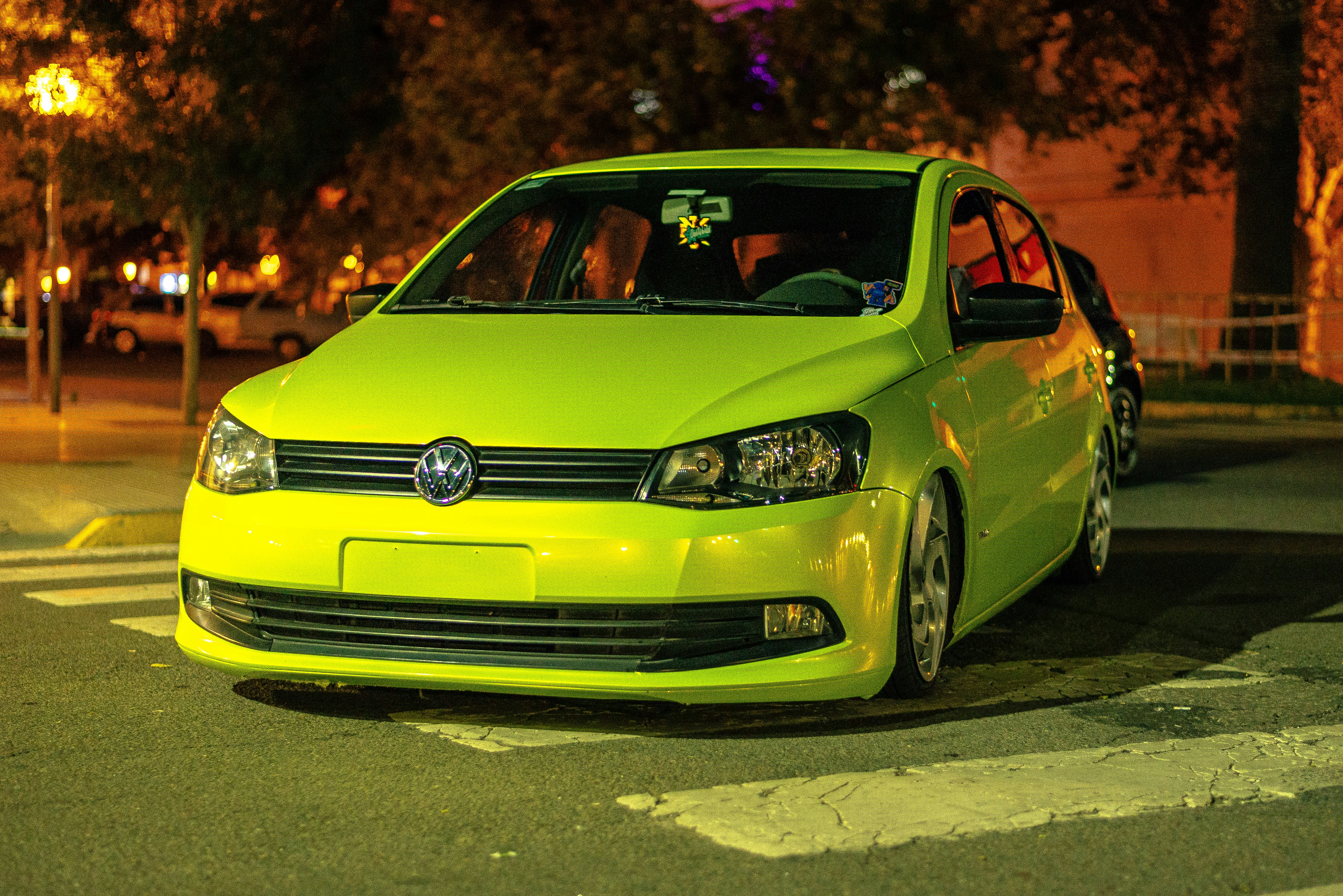 Bright yellow car parked on a road.