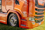 A close-up view of an orange semi-truck.