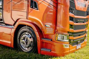 A close-up view of an orange semi-truck.