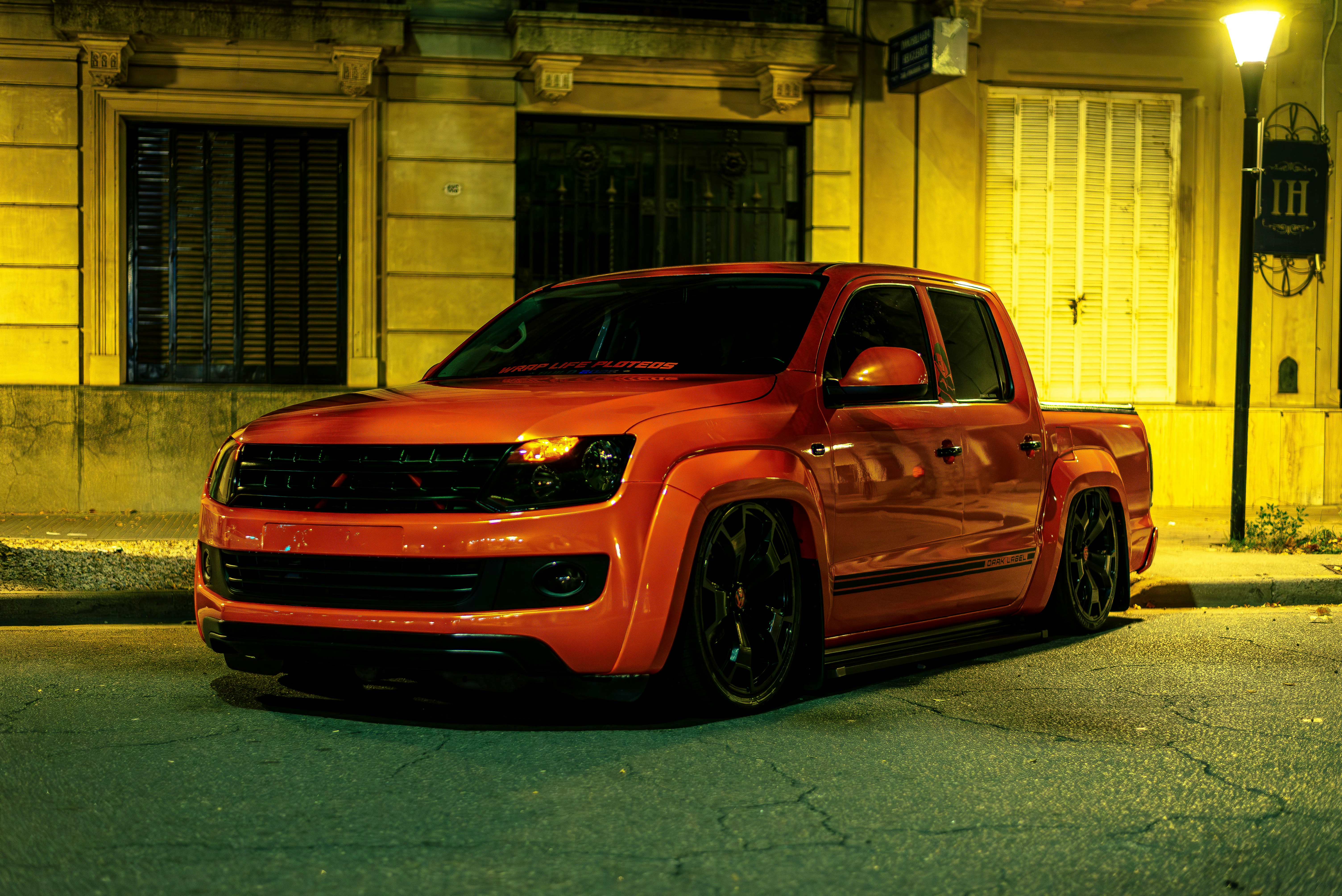 A red pickup truck parks on the street.
