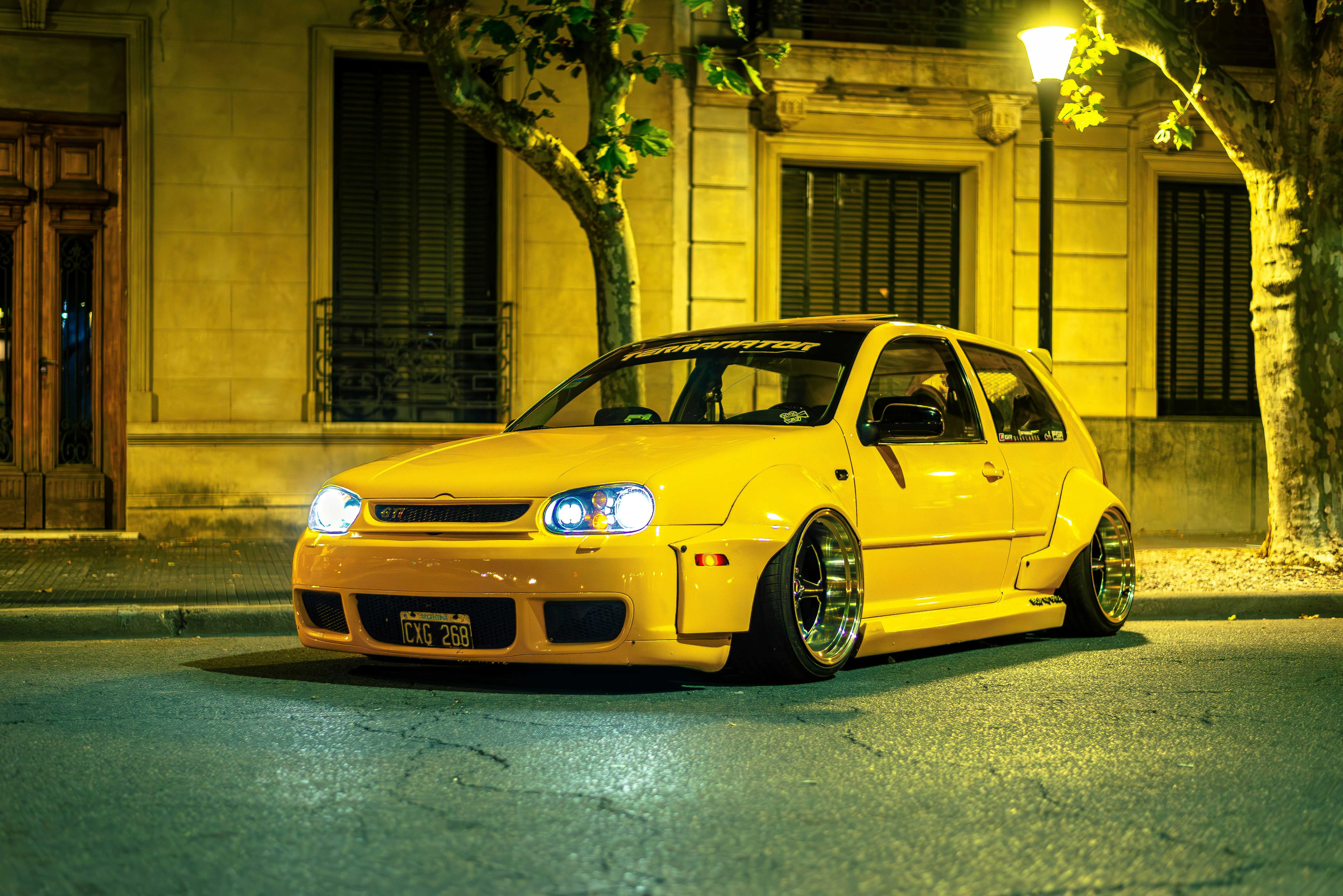 A bright yellow car parked on a street.