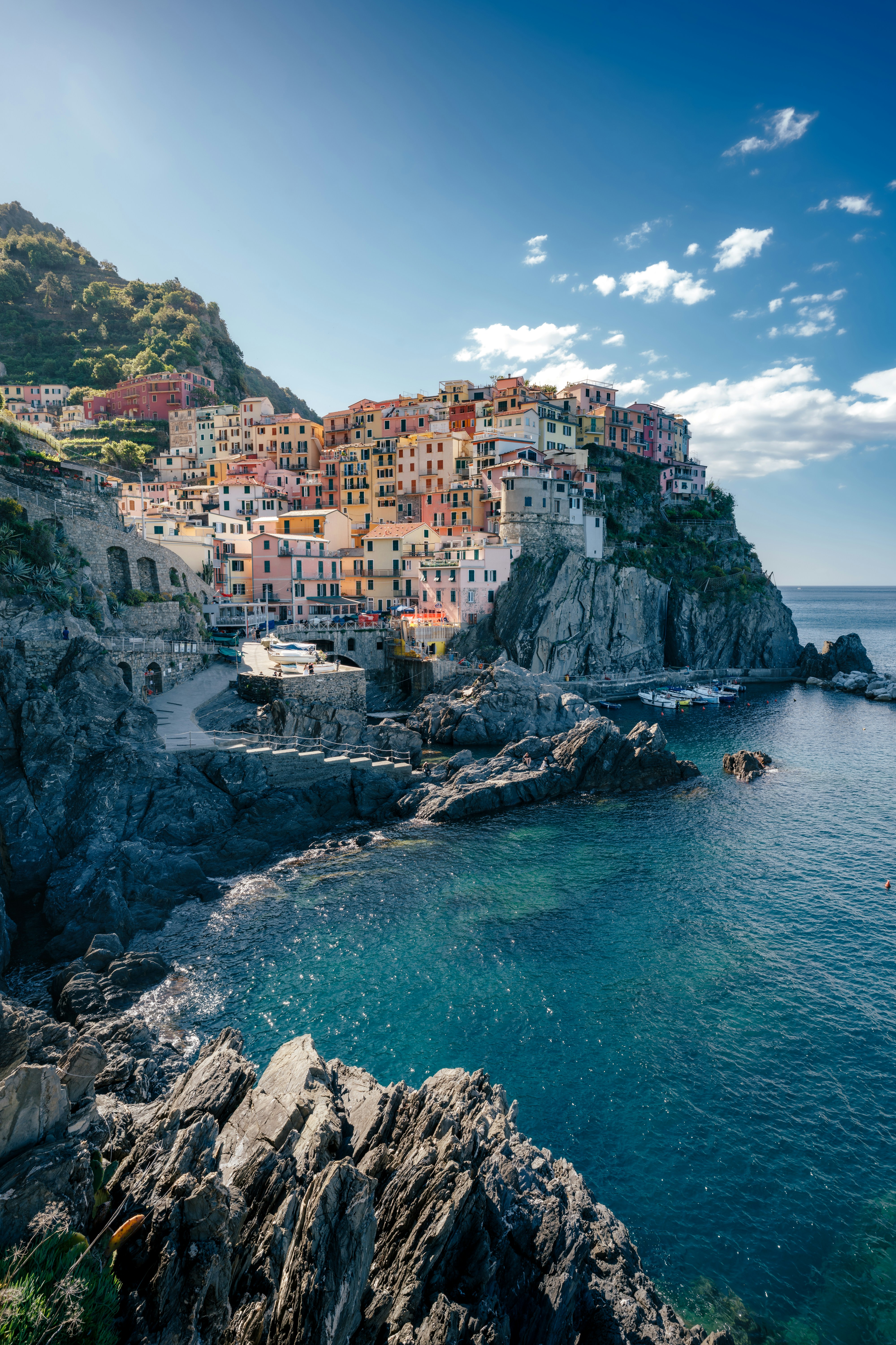 A coastal village sits on a rocky cliff.