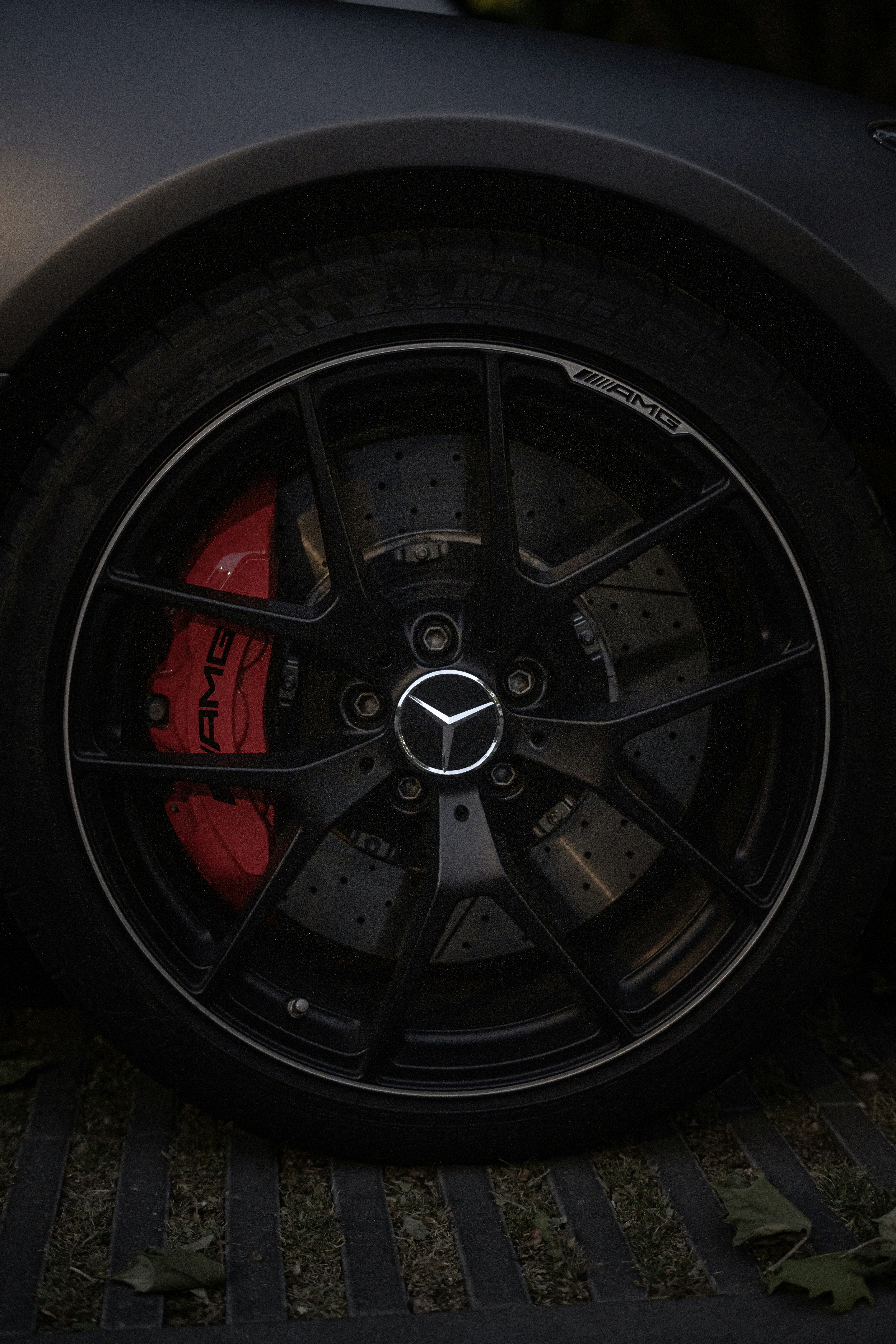 Mercedes-amg wheel with red brake calipers.