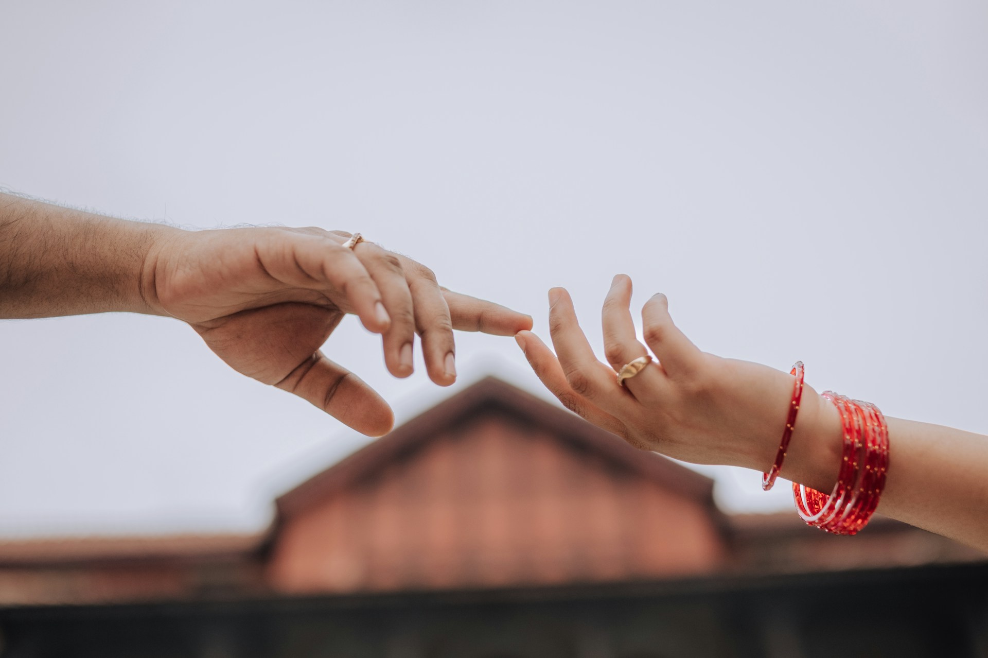 Hands reaching for each other, symbolizing connection.