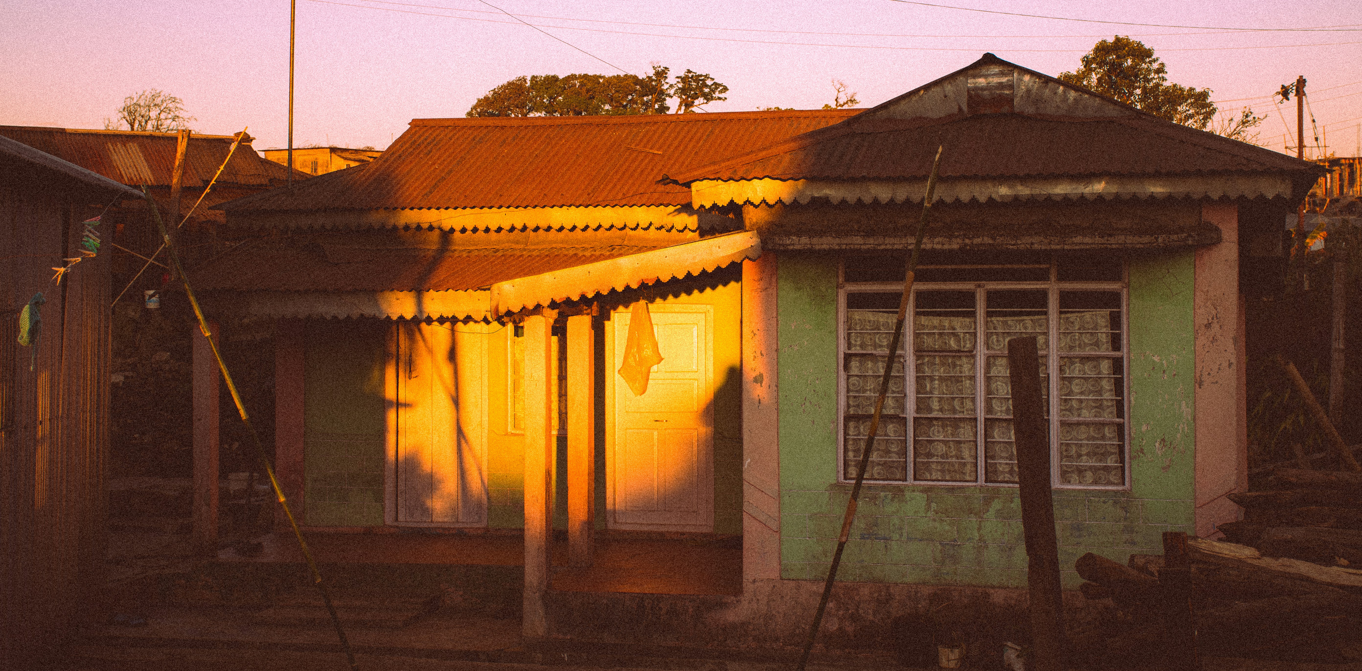 A house is lit by the setting sun.