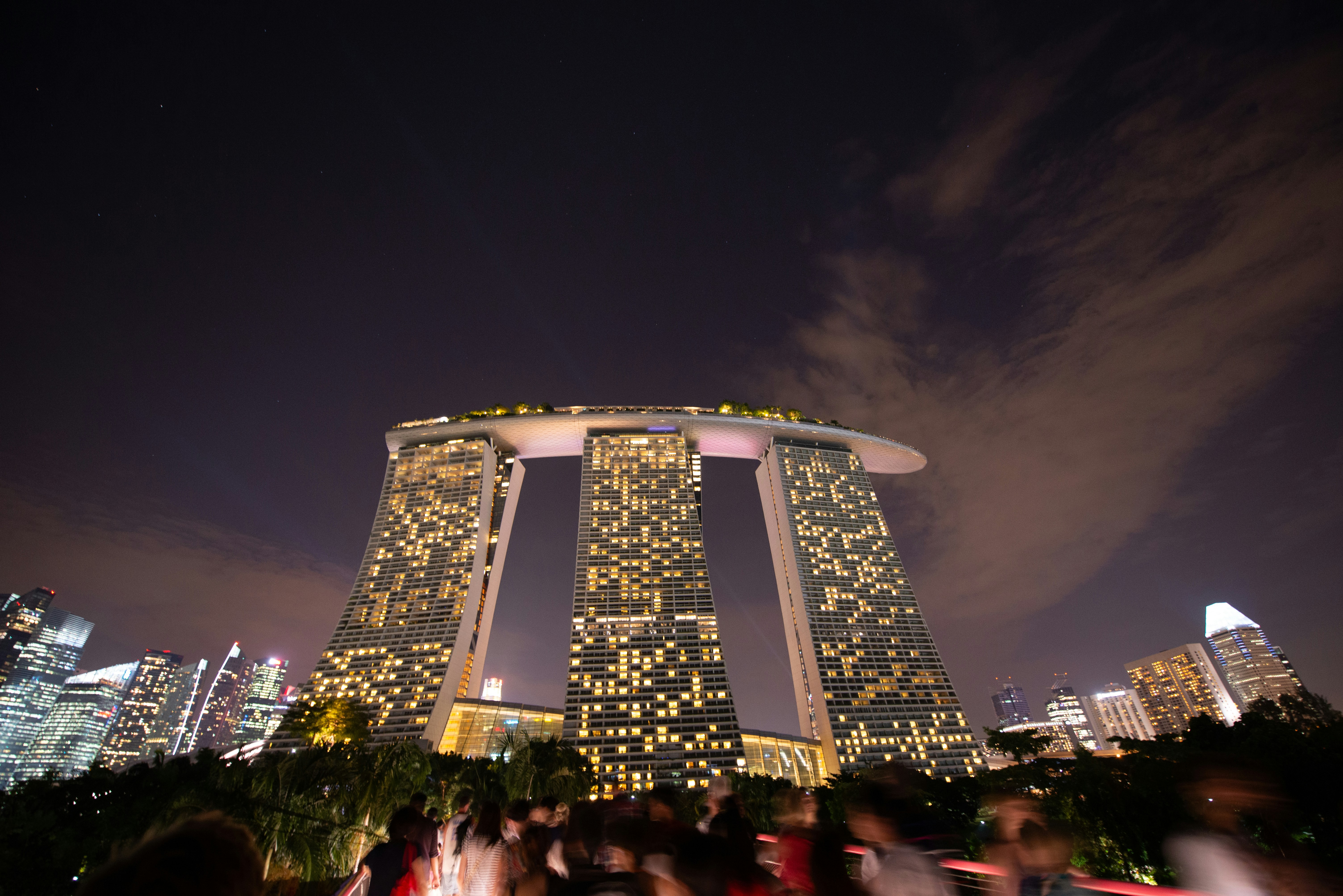 Marina bay sands shines brightly at night.