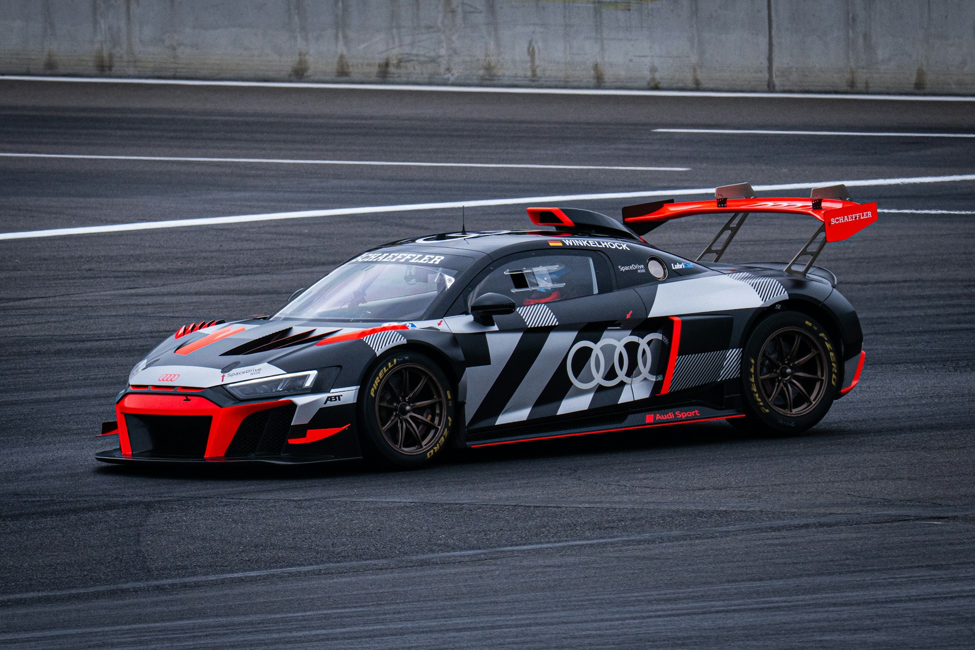 A sleek audi race car speeds along the track.