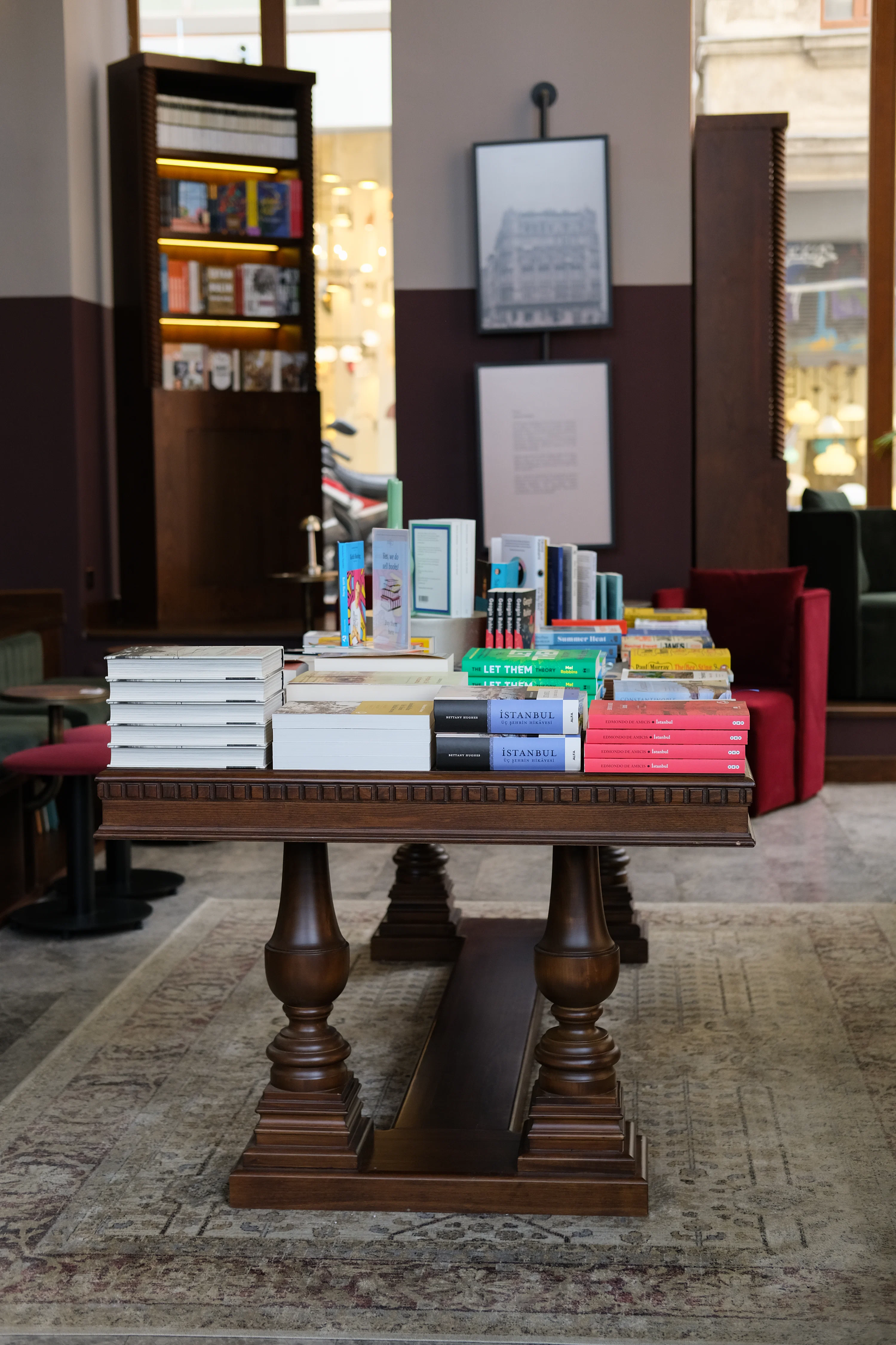 Books are displayed on a wooden table.
