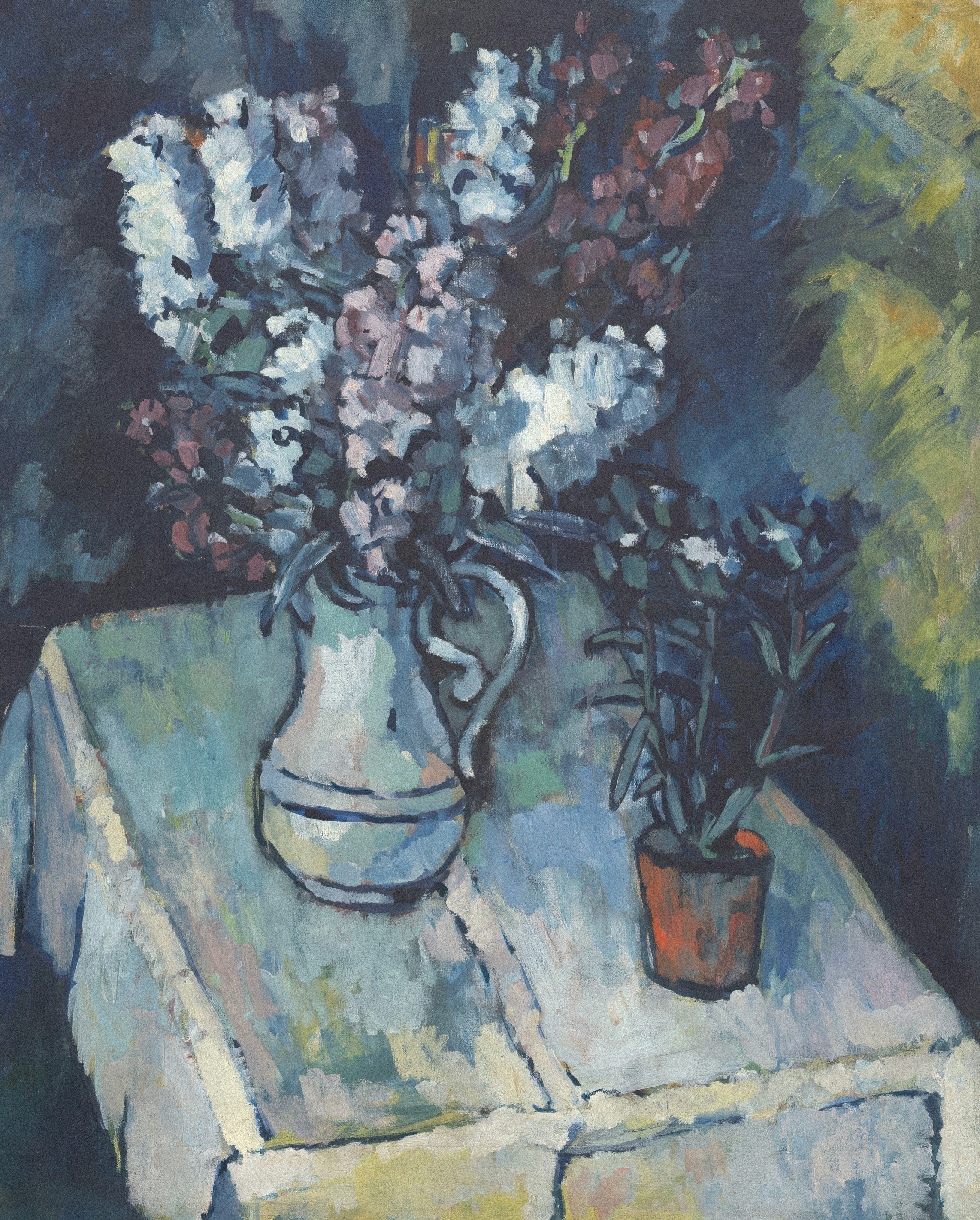 Flowers in a vase sit on a table.