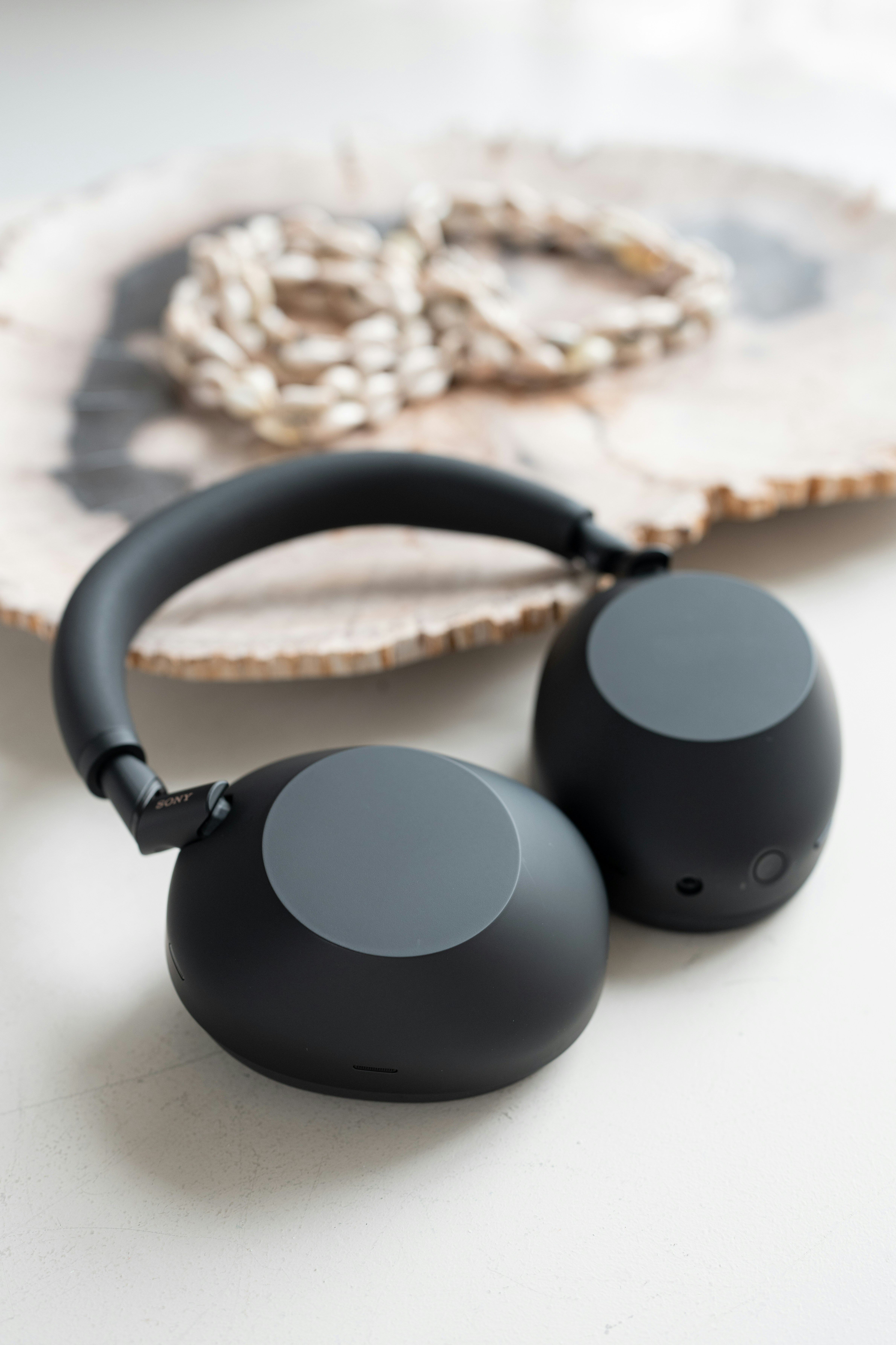 Black headphones rest on a decorative surface.
