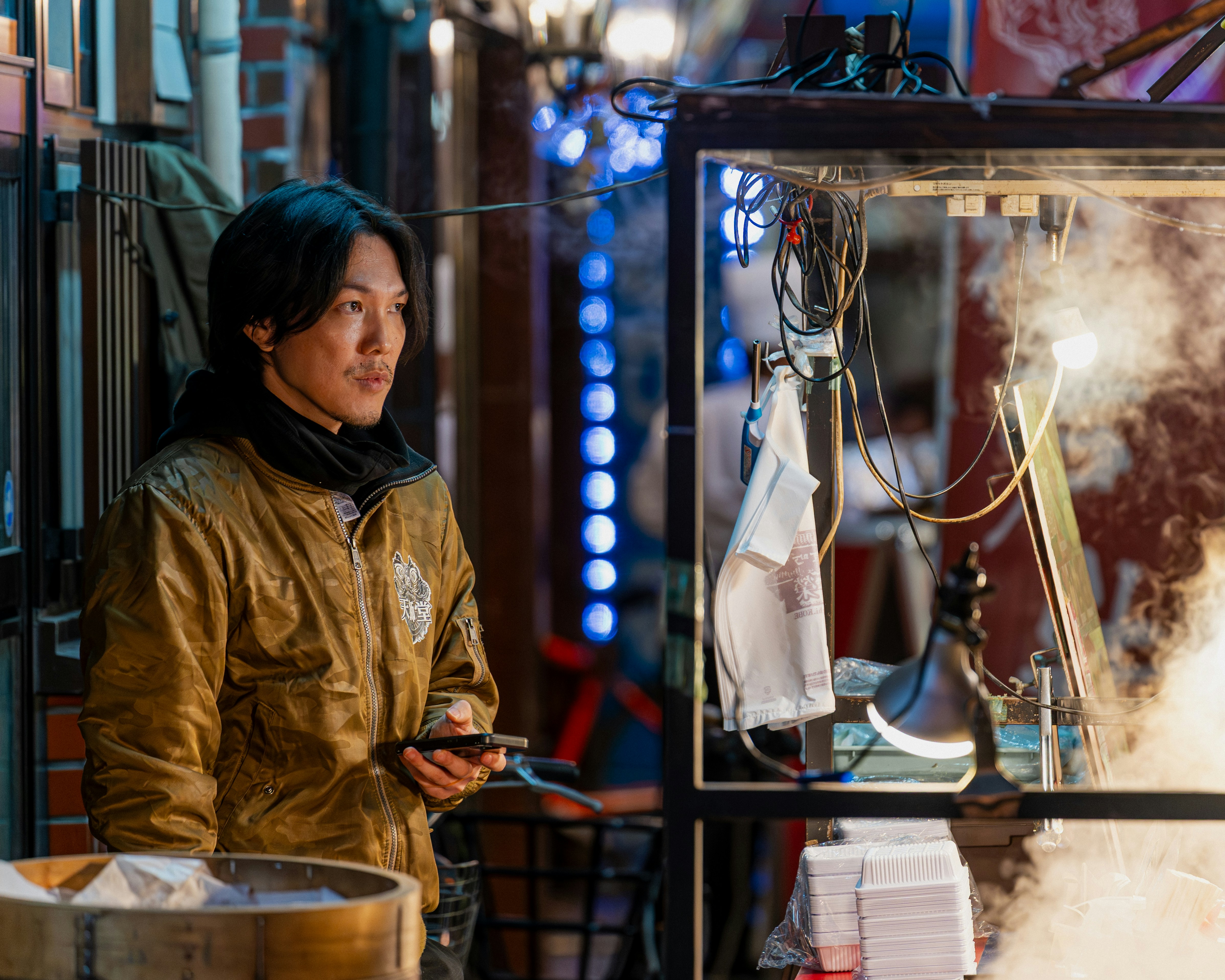 A street vendor looks on.